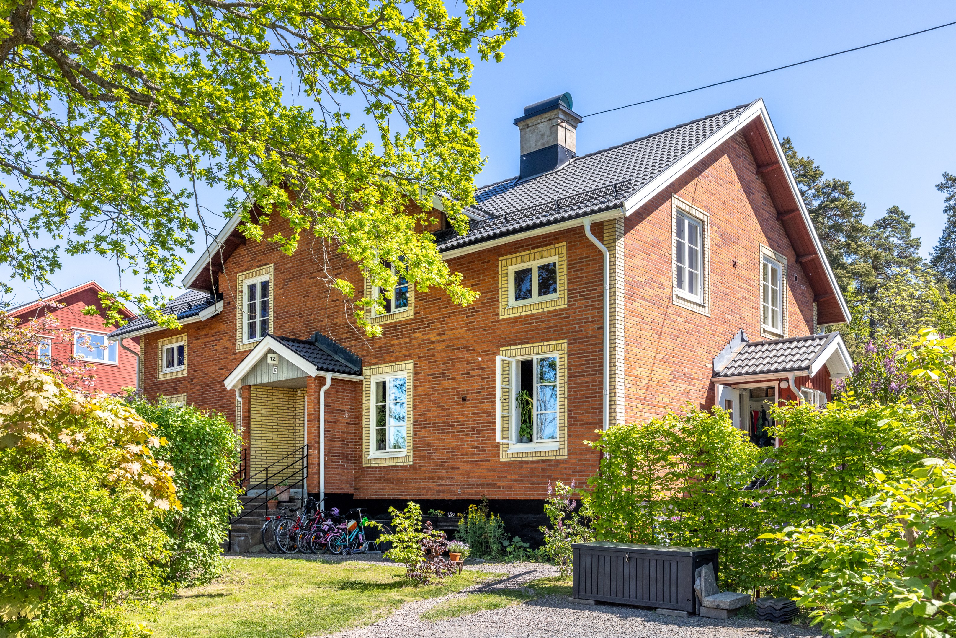 Gavellägenhet med fritt läge i vacker sekelskiftesfastighet - bilen parkeras snett utanför entrén