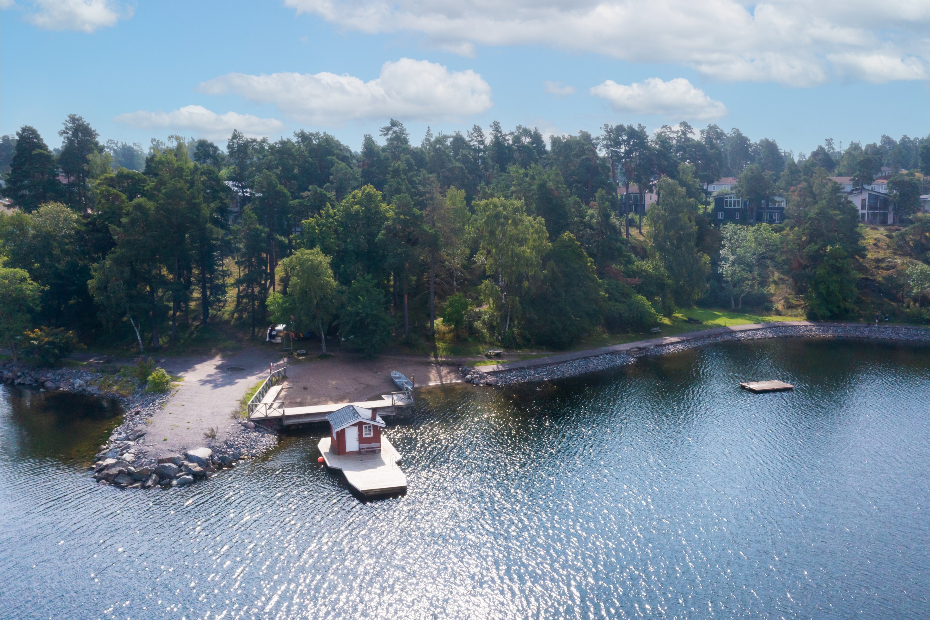 Områdets badplats med bastu rakt nedanför huset