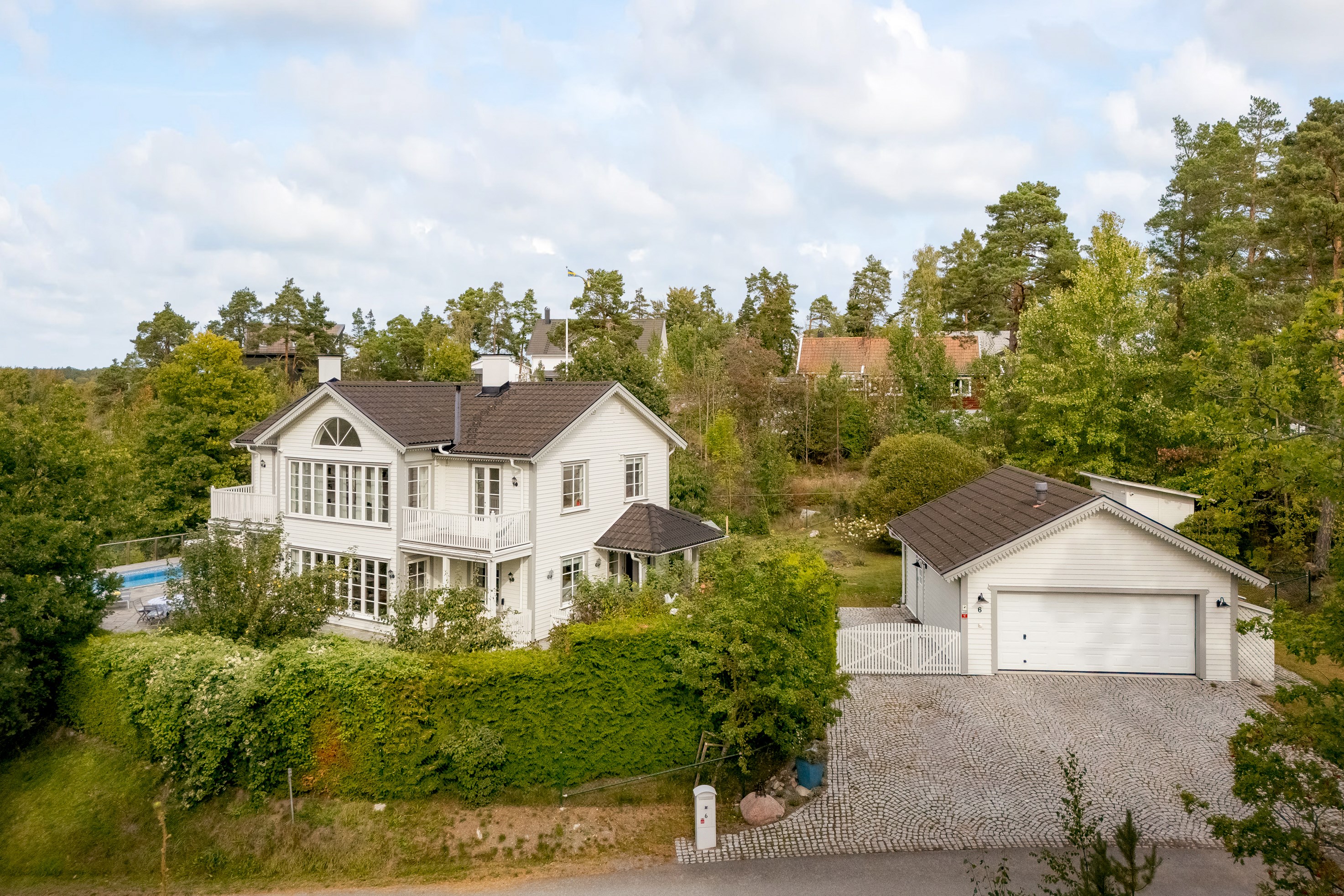 Representativ poolvilla uppförd i sekelskiftesarkitektur.