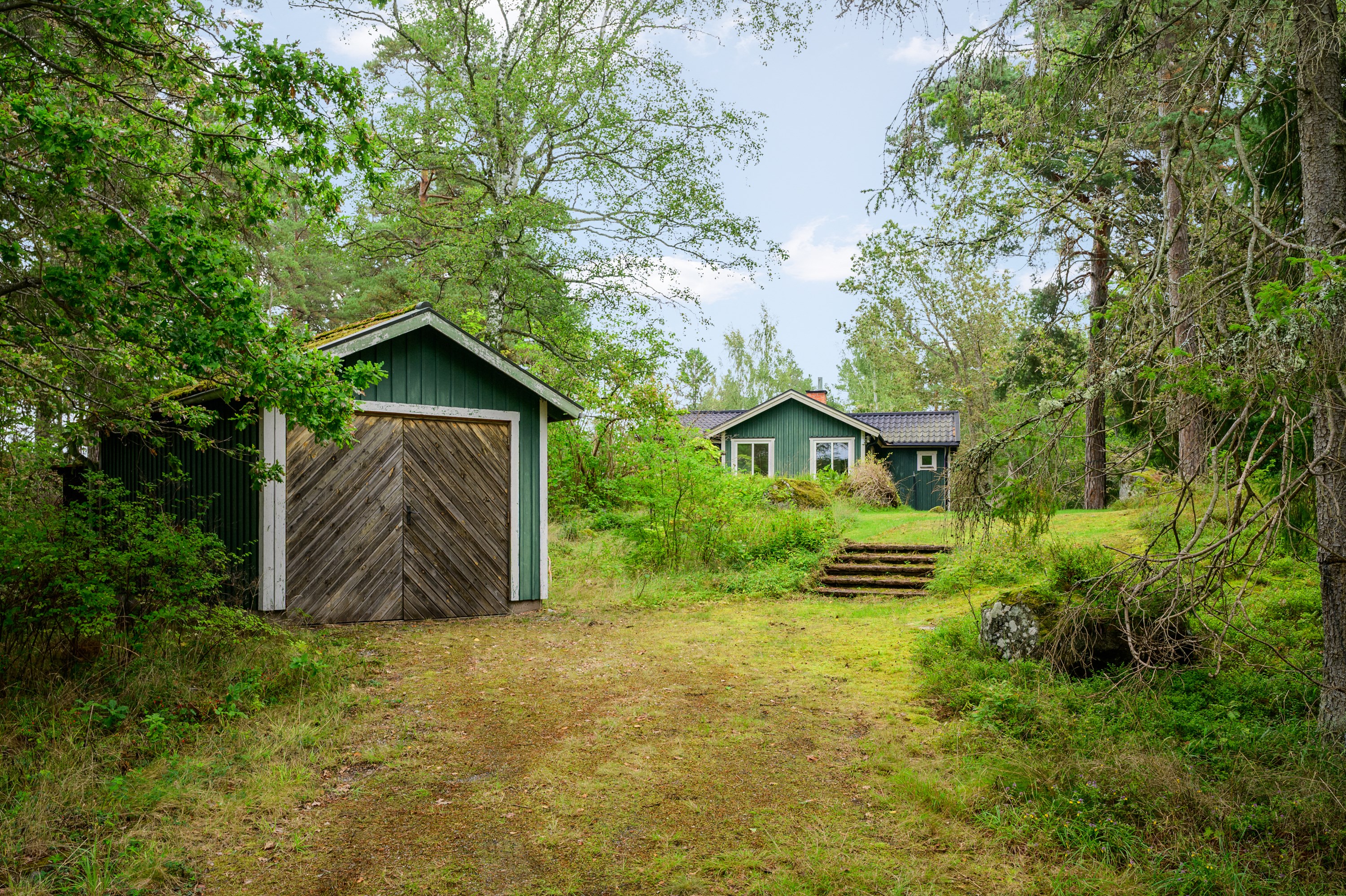 Egen infart med garage och förråd i anslutning till gästhuset.