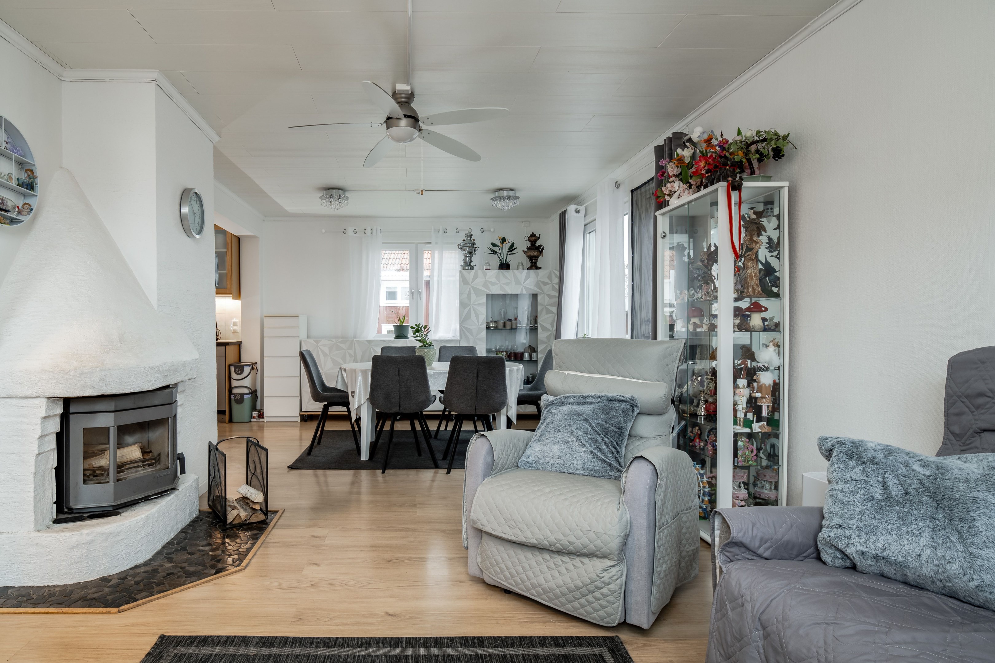 Vardagsrum med kamin öppet mot matplats och kök