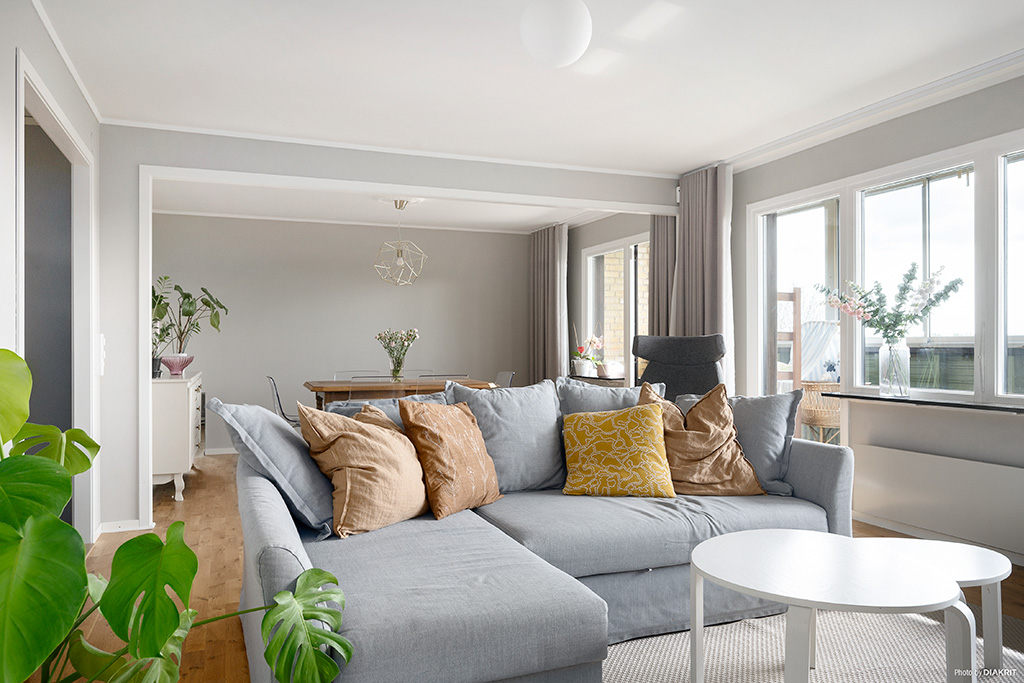 Vardagsrum mot stor inglasad balkong