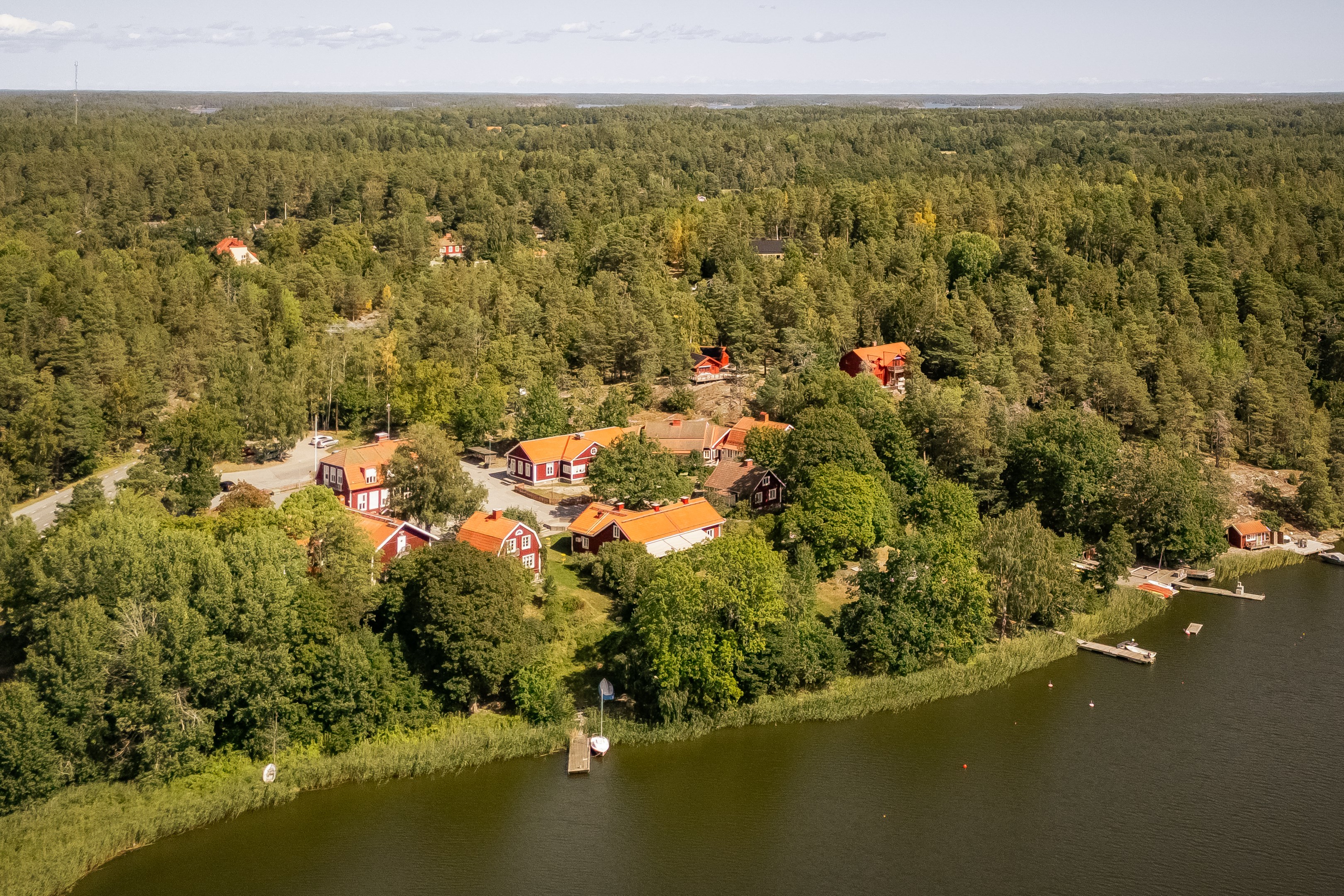 Området i vinkel från Prästfjärden - huset återfinns inbäddat i grönskan snett ovanför Kyrkskolan