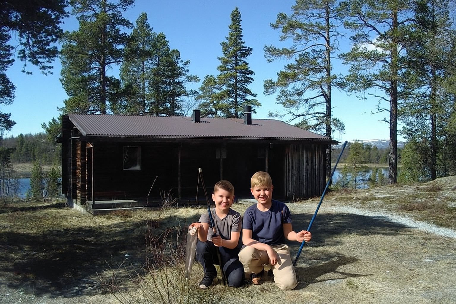 Två glada pojkar fiskelycka