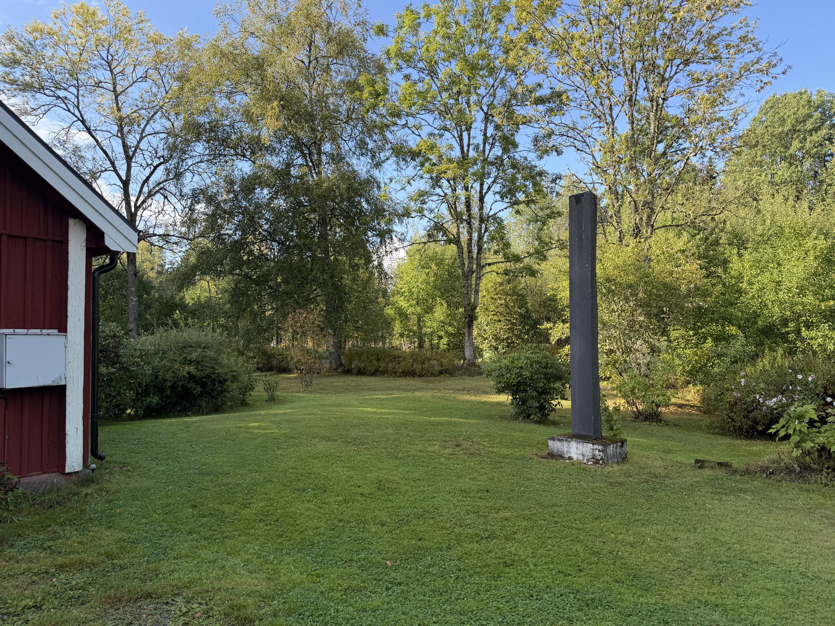 Vacker tomt med skulptur i diabas